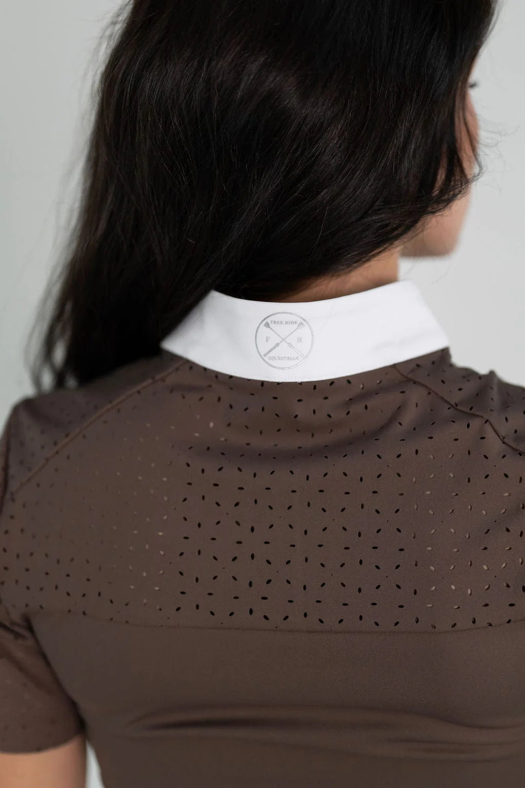 Close-up back view of the laser cut perforations on the back of the brown Free Ride Cassidy Short Sleeve Show Shirt