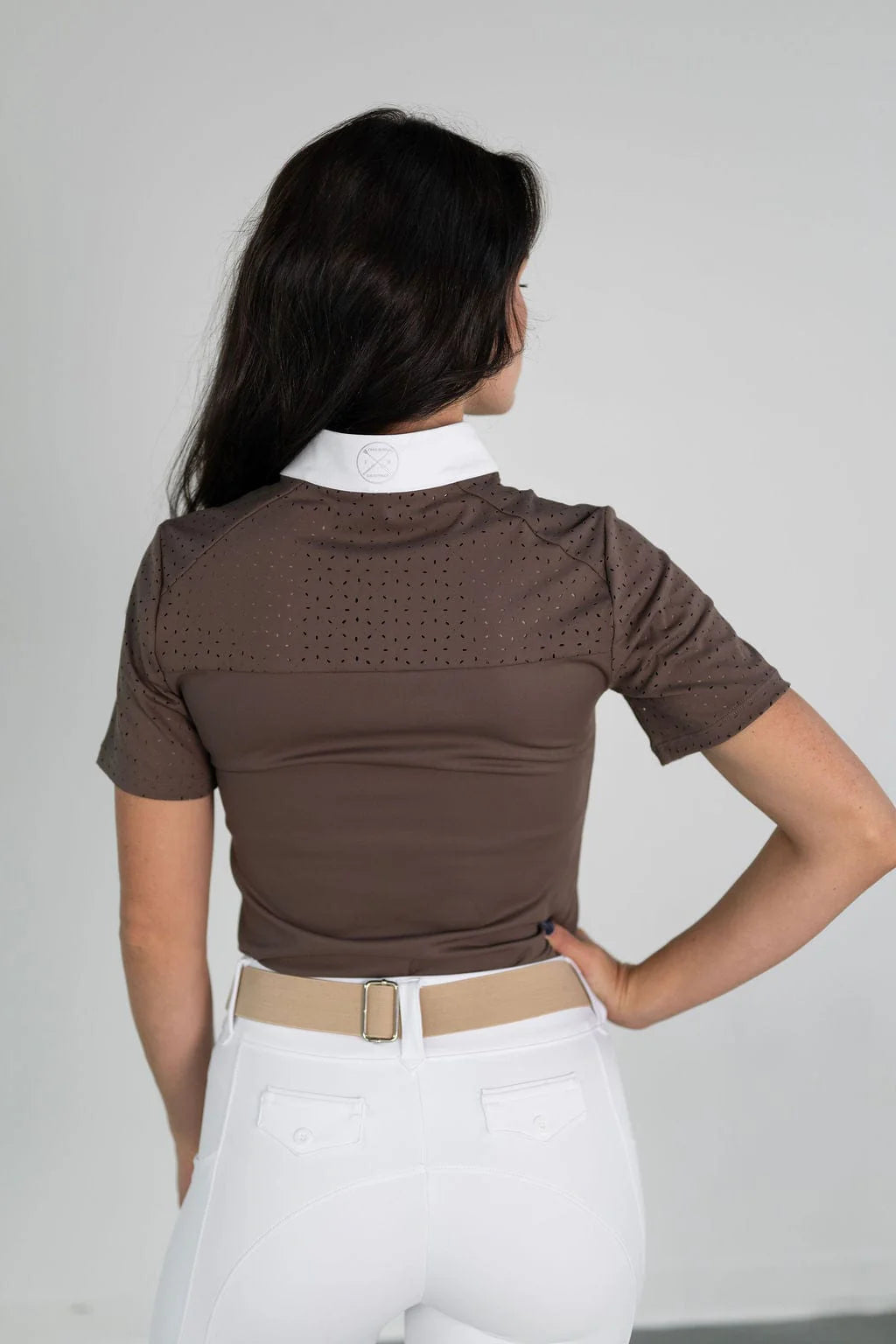 Back view of a female model wearing the brown Free Ride Cassidy Short Sleeve Show Shirt on a plain background
