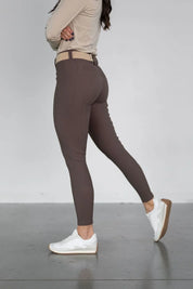 Side view of a model wearing the brown Free Ride PRO Full Seat Breeches on a plain background