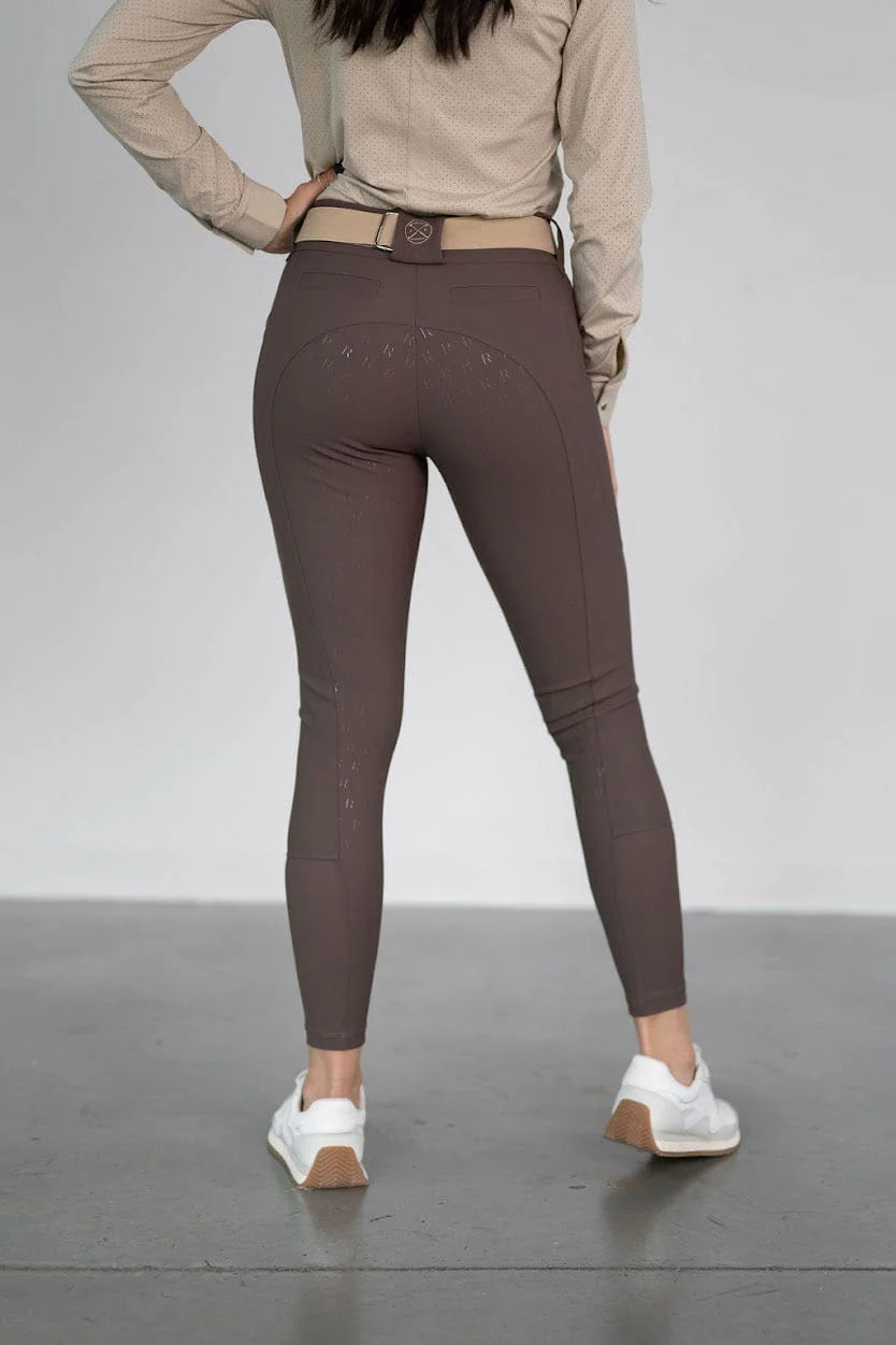 Back view of a model wearing the brown Free Ride PRO Full Seat Breeches on a plain background