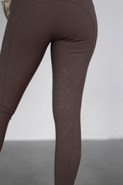 Close-up rear view of a model wearing the urban bronze Free Ride PRO Knee Patch Breeches on a plain background