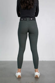 Back view of a model wearing the green Free Ride PRO Full Seat Breeches on a plain background