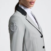 Close-up angled front view of a female model wearing the gray Cavalleria Toscana GP Perforated Riding Jacket on a plain background