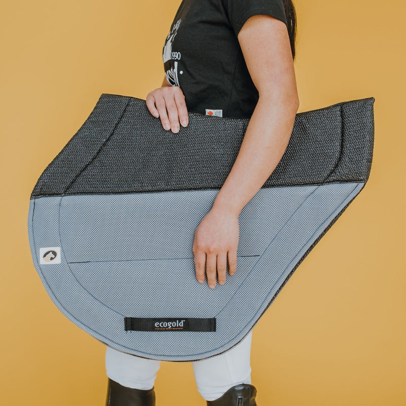 Side view of the grey Ecogold Secure Cross Country Pad on a yellow background