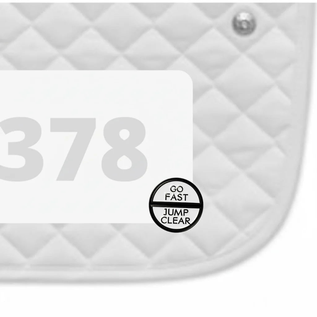 Side view of a white pad with numbers 378 and a Go Fast Jump Clear Dubois Cheval Number Pin Charm on a white background