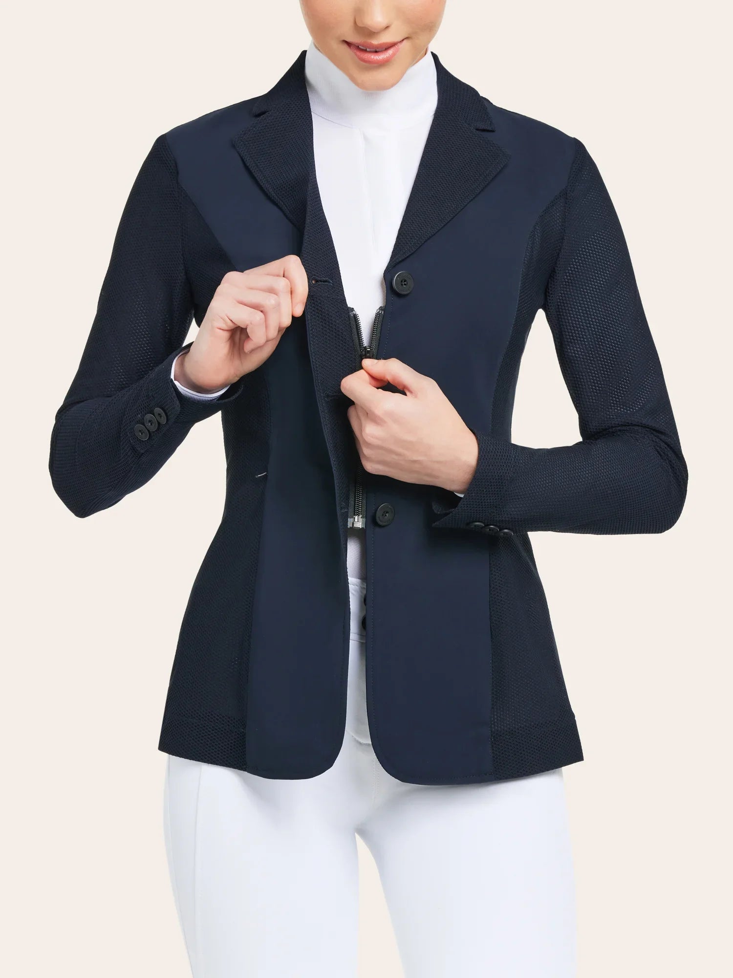 Front view of a female model unzipping the navy RJ Classics Harmony Mesh Coat on a white background