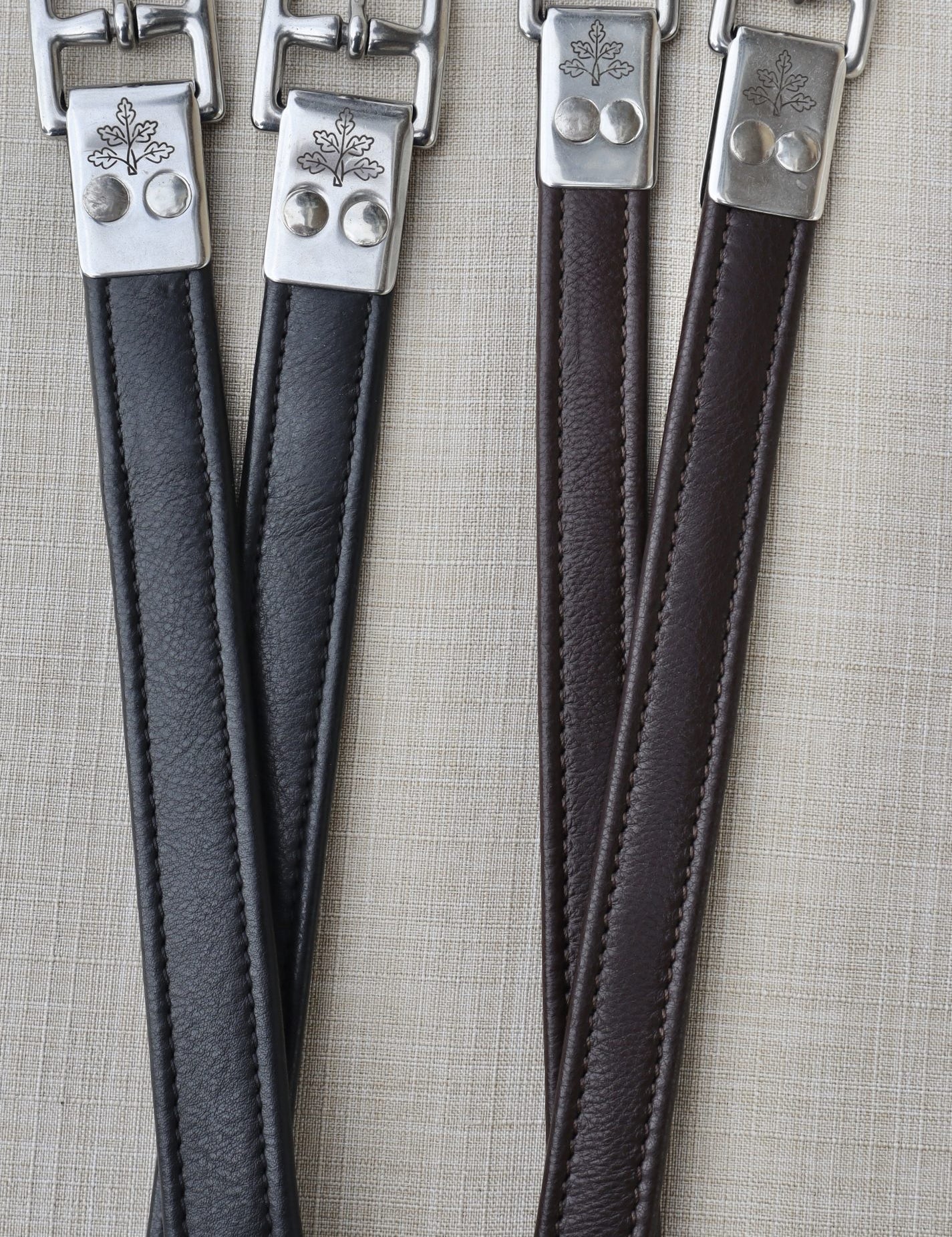 Side-by-side views of a black pair and a brown pair of the Black Oak Calf Lined Leathers on a textured background