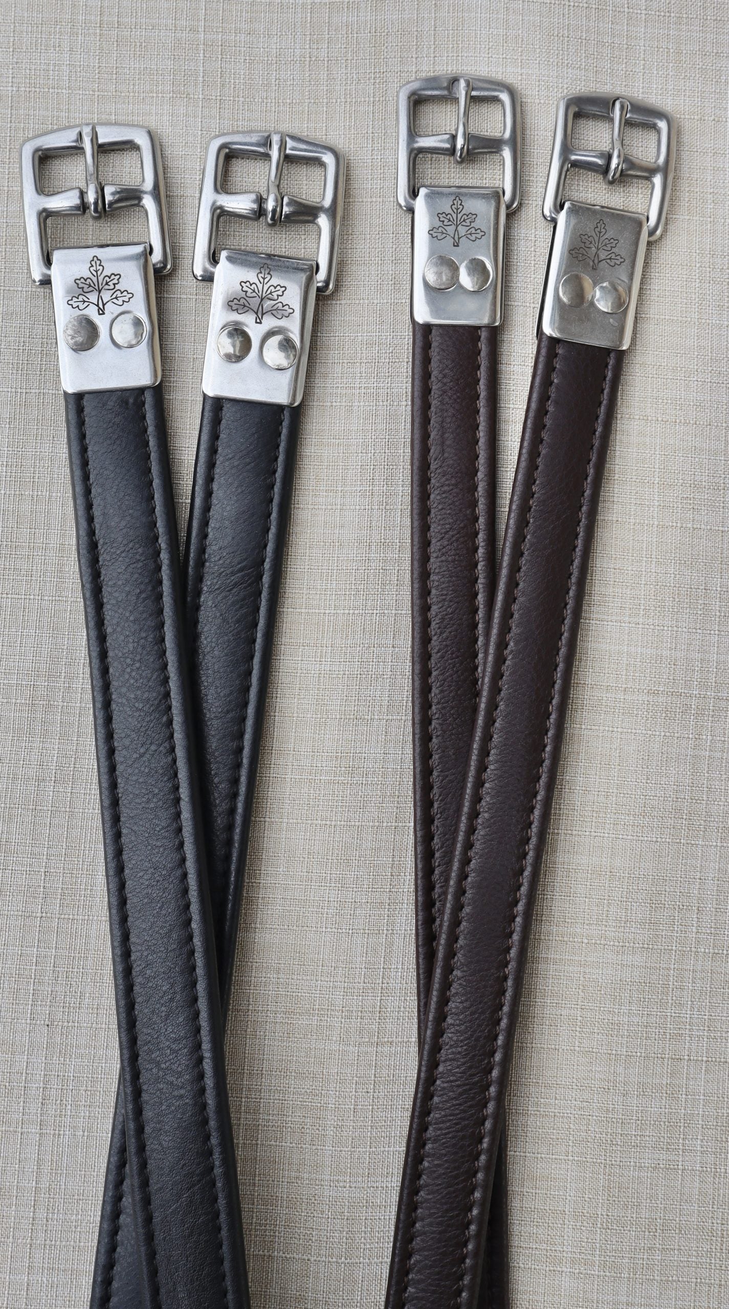 Side-by-side views of a black pair and a brown pair of the Black Oak Calf Lined Leathers on a textured background