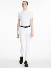 Model wearing LeMieux Isabelle Full Seat Breeches in White with black belt and black athletic shoes