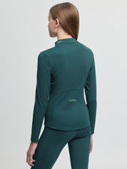 Back view of model wearing LeMieux Young Rider Airflow Base Layer in Jungle showing high collar and LeMieux logo on lower back