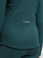 Close-up of LeMieux Young Rider Airflow Base Layer in Jungle showing LeMieux logo on lower back