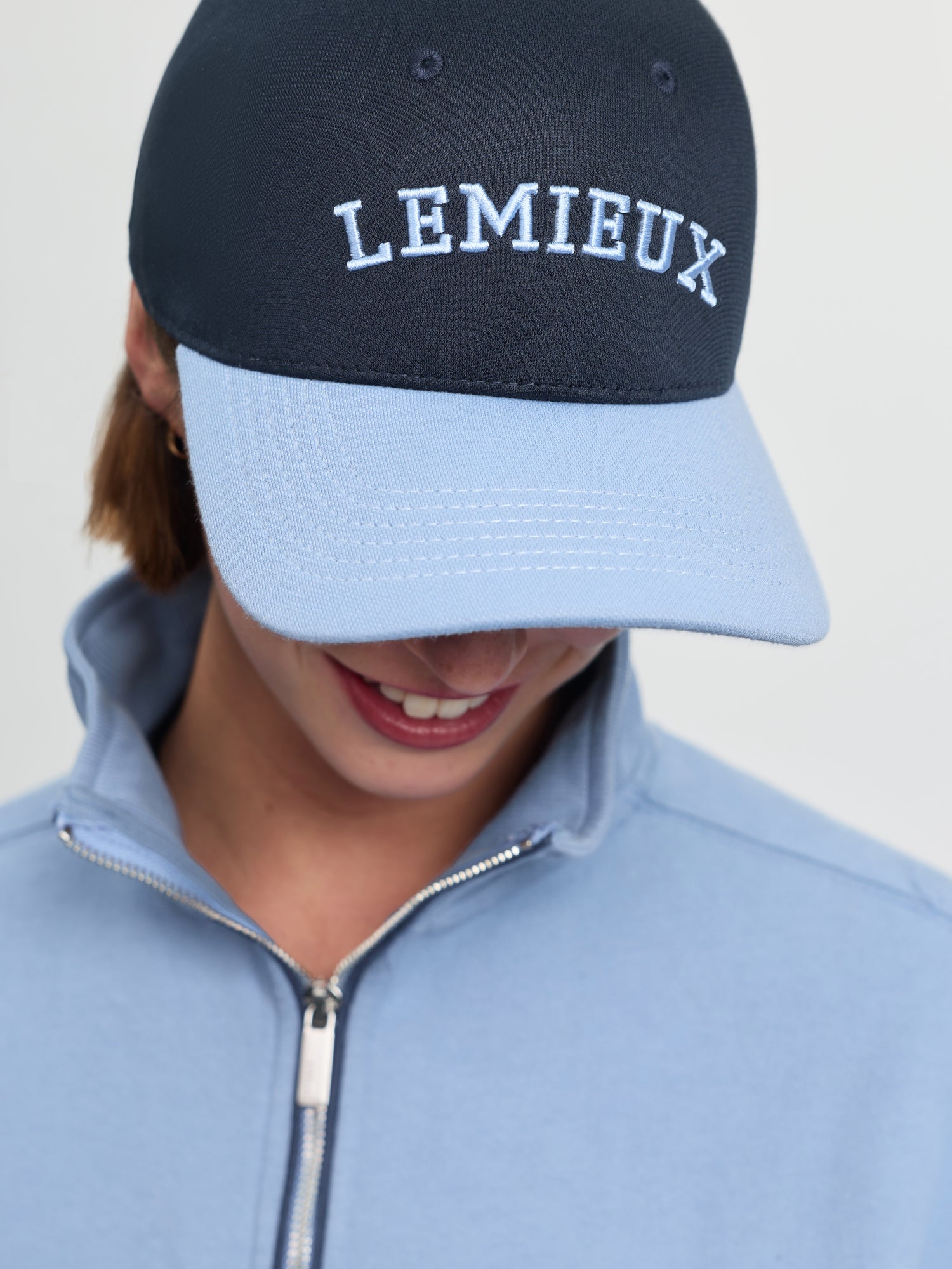 Close-up of LeMieux Ashley Cap in Shadow showing embroidered LeMieux logo and contrasting curved brim