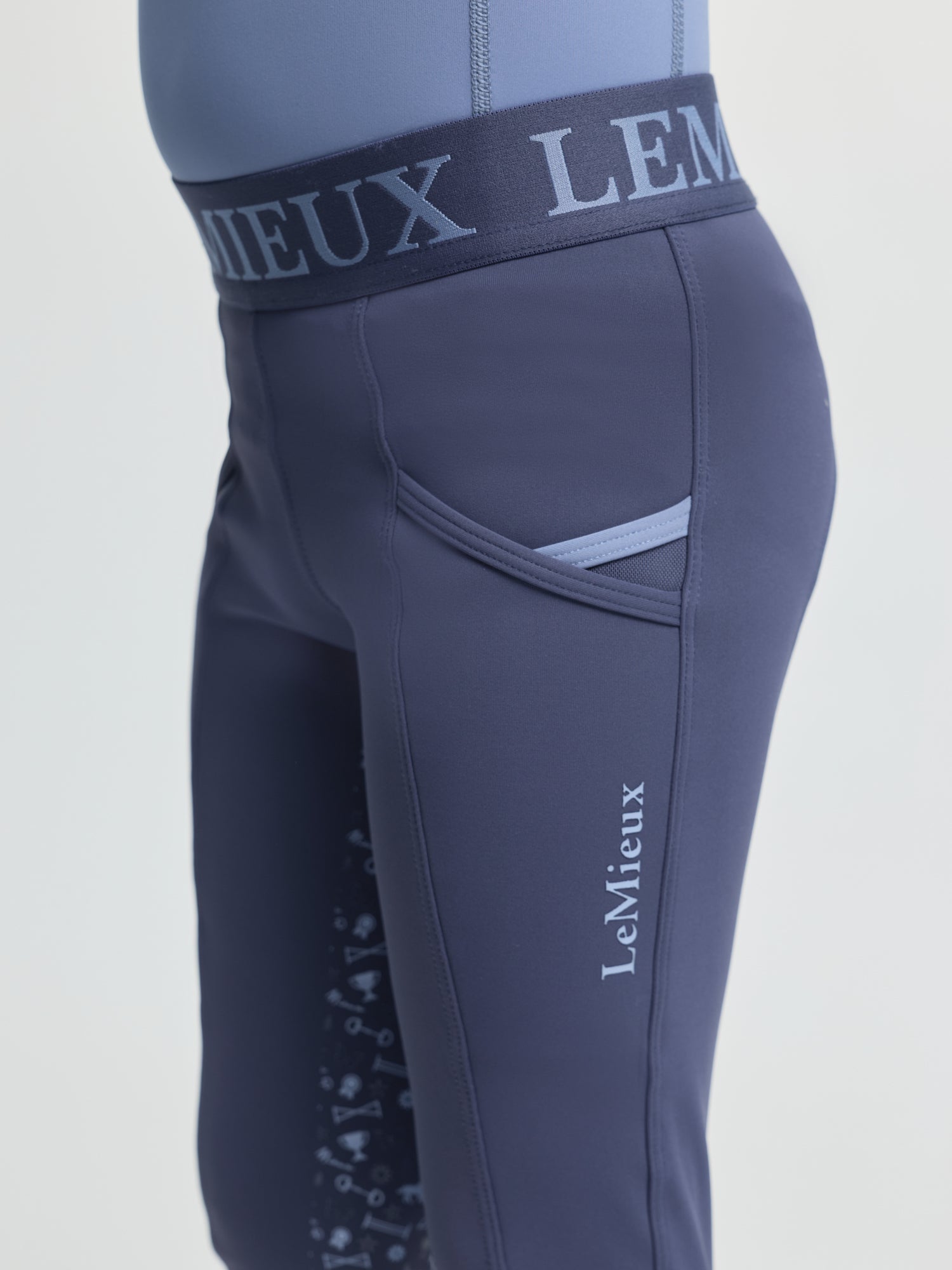 Close-up of LeMieux Mini Pull On Breech in Shadow showing elastic logo waistband and side pocket detail