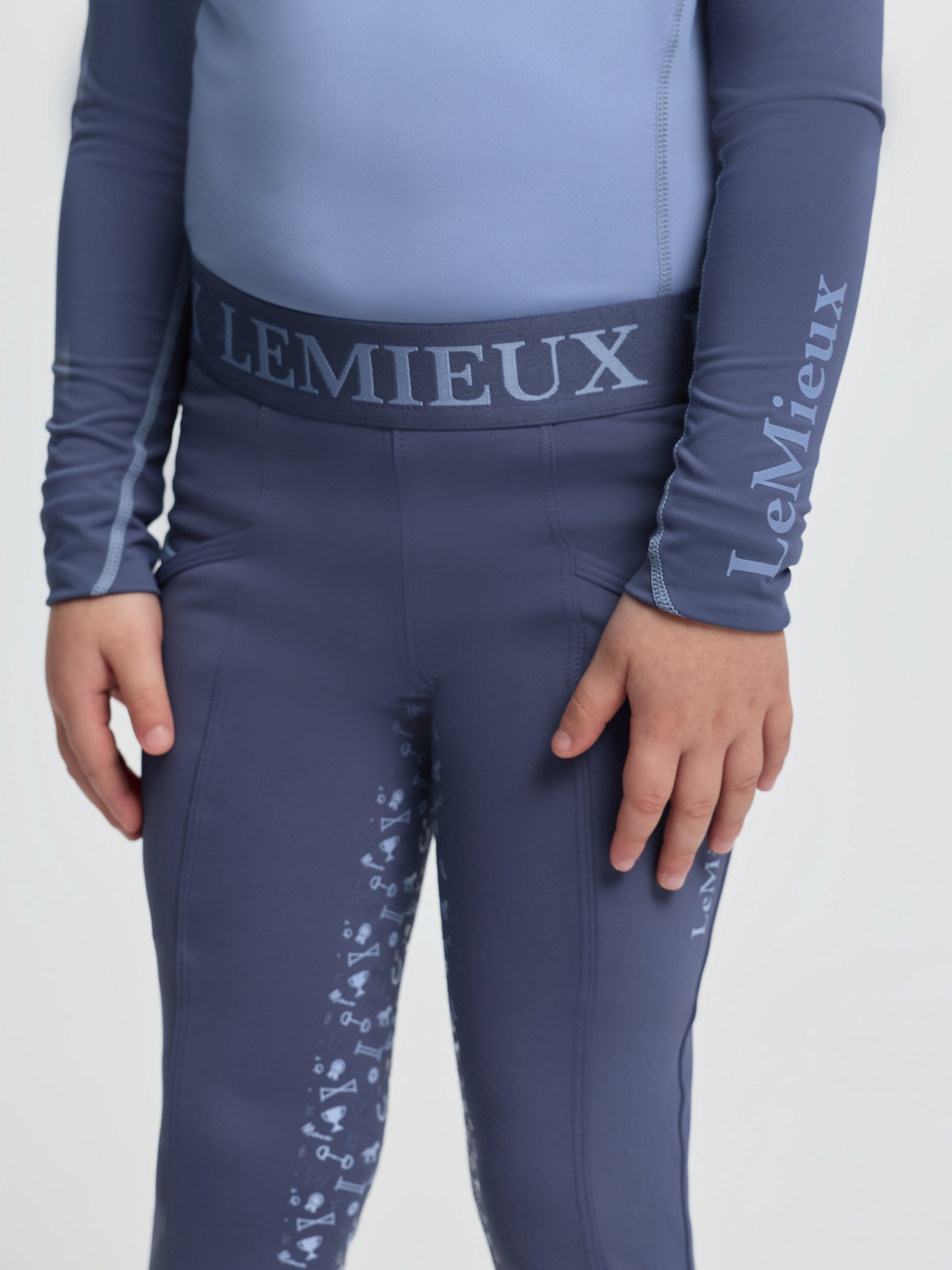 Front view of LeMieux Mini Pull On Breech in Shadow with elastic logo waistband and silicone grip print on inner legs