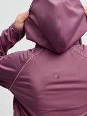 Close-up back view of LeMieux Young Rider Paige Quarter Zip Waterproof Jacket in Mallow with hood raised and snap fastenings