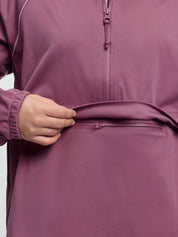 Close-up of LeMieux Young Rider Paige Quarter Zip Waterproof Jacket in Mallow showing quarter zip and front zip pocket