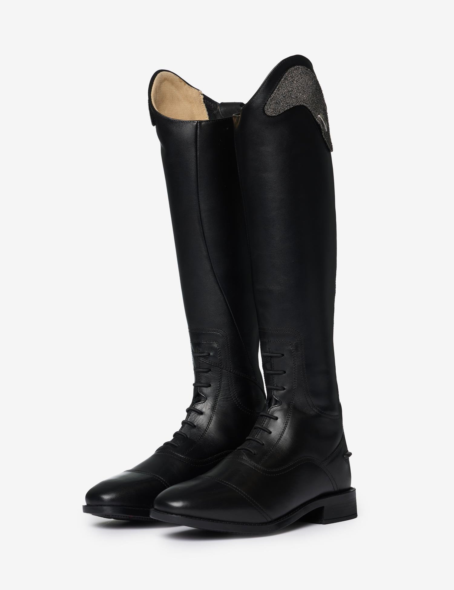 Angled view of a pair of LeMieux Junior Interchangeable Riding Boots in Black with laces on the front of the ankle