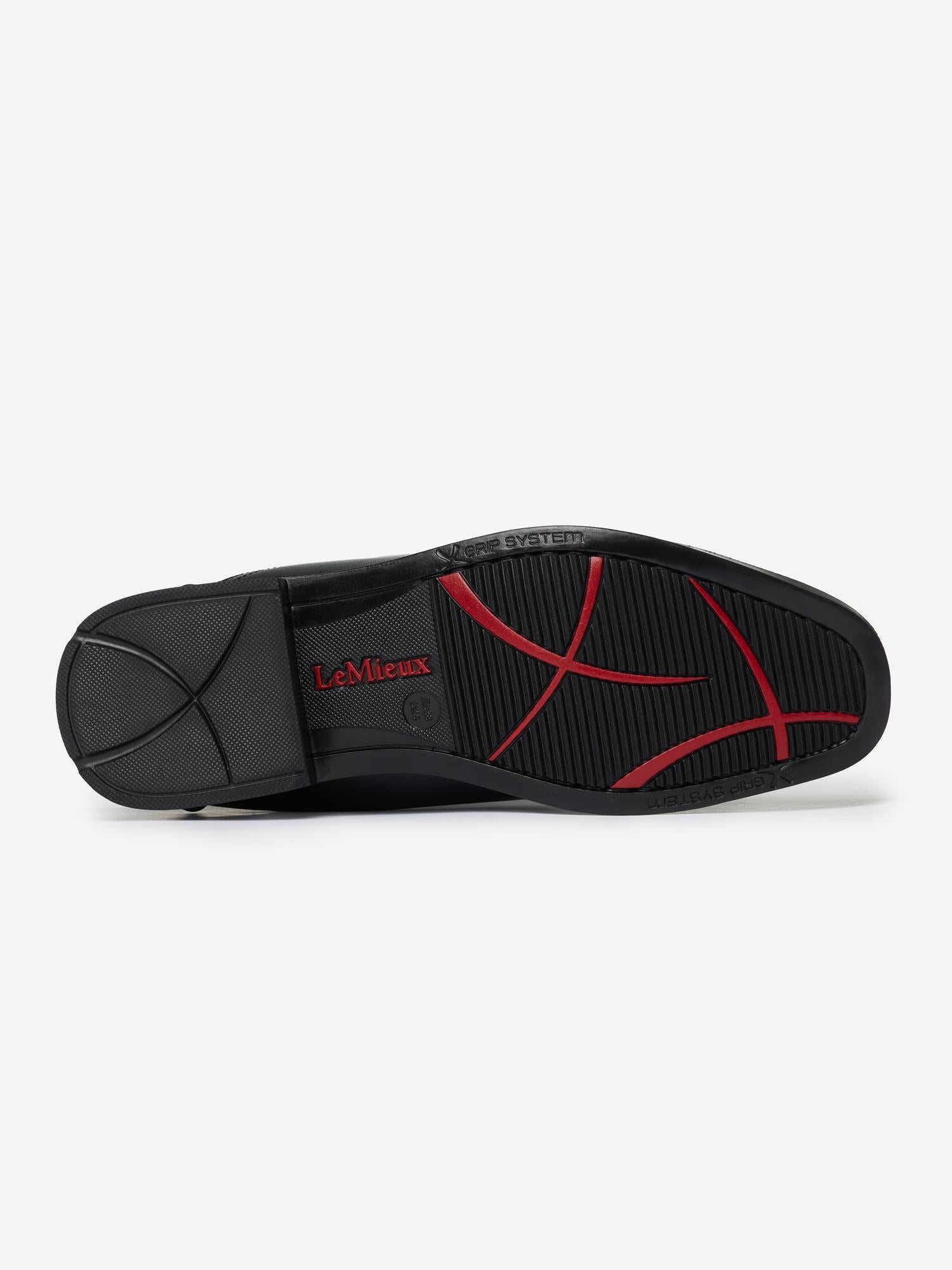 Bottom view of the black and red sole pattern of a LeMieux Junior Interchangeable Riding Boot