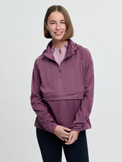 Model wearing LeMieux Perri Half Zip Waterproof Jacket in Mallow with hood and half zip front