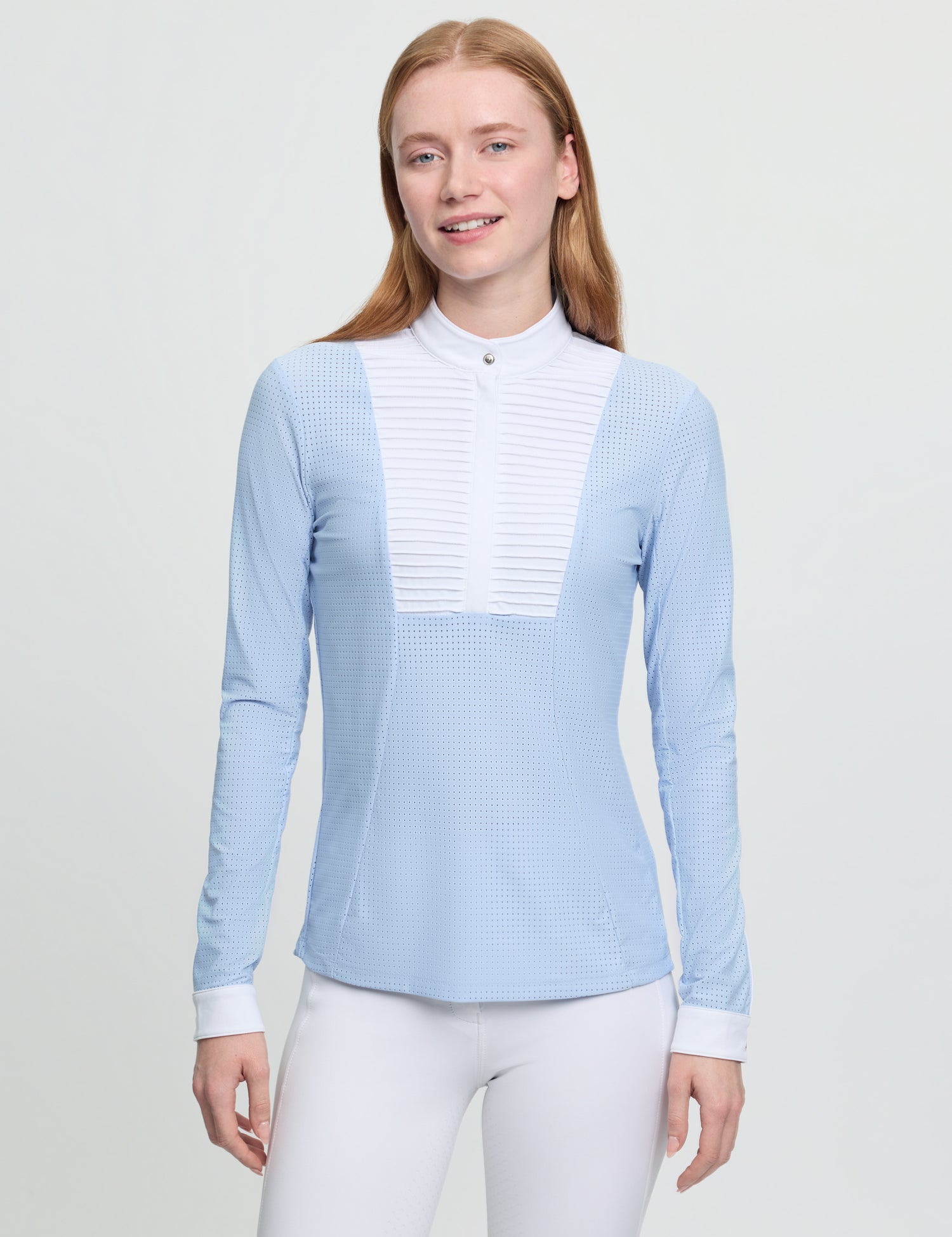 Model wearing LeMieux Arielle Long Sleeve Show Shirt in Mist with white stand collar and pleated bib front