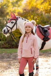 Front view of a young female model wearing Petal LeMieux Mini Maggie Heart Fleece and standing outdoors