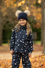 Front view of a young female model wearing Navy LeMieux Mini Pippin Splash Jacket and standing outdoors