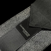 Close-up view of a black Incrediwear Circulation Exercise Bandage on a black background