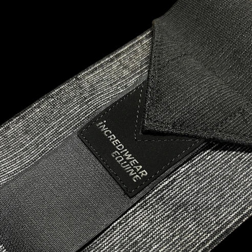 Close-up view of a black Incrediwear Circulation Exercise Bandage on a black background