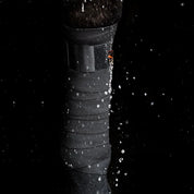 View of a black Incrediwear Circulation Exercise Bandage on a horse's leg with water droplets surrounging it on a black background