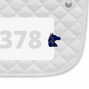 Side view of a white pad with numbers 378 and an "It's A Write Off" Dubois Cheval Number Pin Charm on a white background