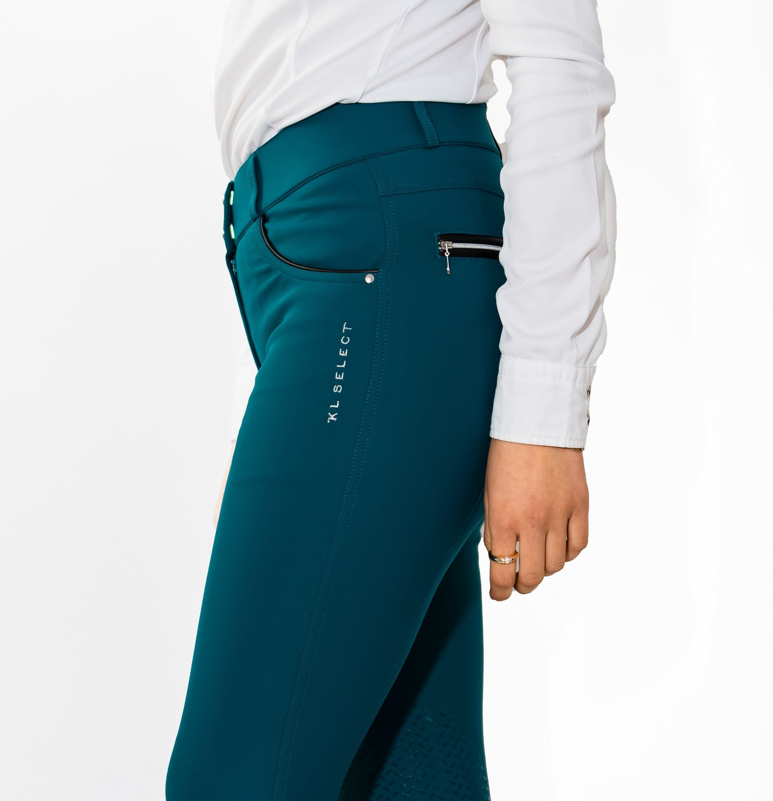 Side view of a model wearing the teal KL Select Gabrielle Breech on a white background