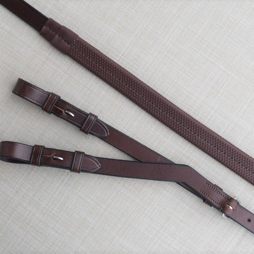 Side-by-side front and back views of the KL Select Rubber Converter Reins on a patterned background