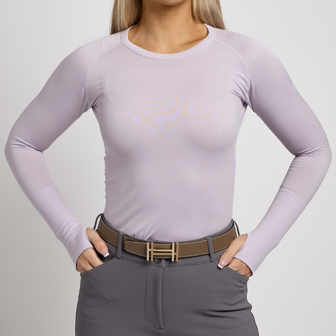 Front view of a female model wearing the Charm TKEQ Kennedy Seamless Long Sleeve Shirt 2.0 on a white background