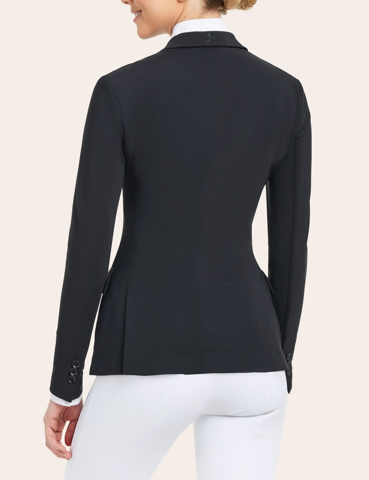 Back view of a model wearing the black RJ Classics Monterey Show Coat on a plain background