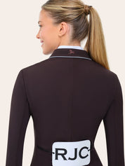 Back-detail view of the RJ Classics Monterey Show Coat in fig featuring a smooth tailored fit, contrast piping along the collar, and an embroidered logo at the back neck, shown over a white show shirt on a model against a plain light background.