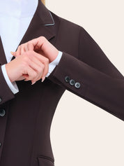 Close-up of the RJ Classics Monterey Show Coat in fig showing the notched lapel with contrast piping, smooth stretch fabric, and buttoned sleeve cuff over a white show shirt.