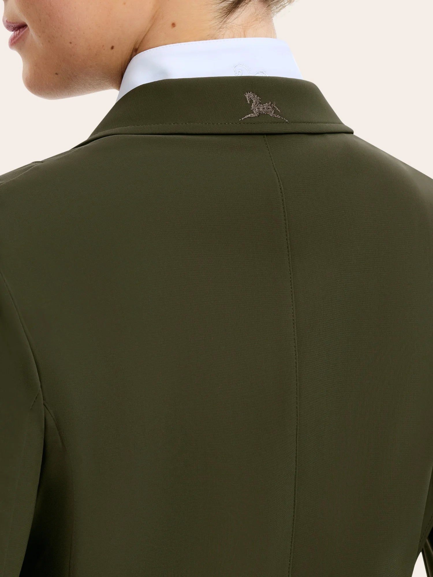 Close-up back view of the collar on the vintage olive RJ Classics Monterey Show Coat on a plain background