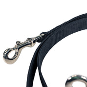 Close-up view of the black Nunn Finner Rapid Release Cross Tie on a white background