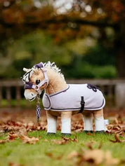 Light purple cooler on a stuffed animal fjord horse outside