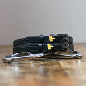 Front view of the buckled Thumbs Up Mane Jane Spur Straps on wood