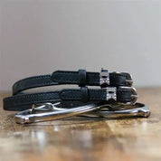 Front view of the buckled IDK Mane Jane Spur Straps on wood