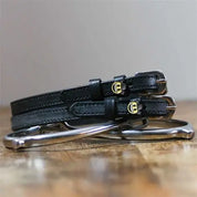 Front view of the buckled Cowboy Emoji Mane Jane Spur Straps on wood