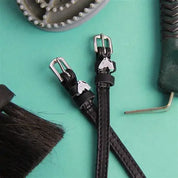Front view of the Gray Horse Mane Jane Spur Straps on a green background
