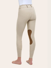 Angled back view of the RJ Classics Olivia Luxe-Tek Breech in Sand showing the contoured seat seams, belt loops, smooth stretch fabric, brown suede knee patch, and perforated lower-leg panels, photographed on a model against a plain light background.