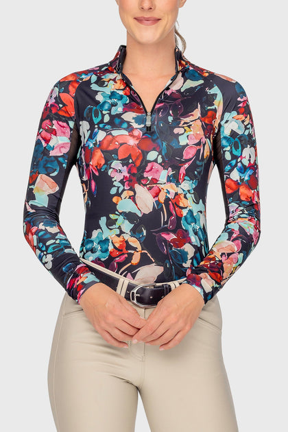 Front view of a female model wearing the Black Watercolor Floral Kastel 1/4 Zip Long Sleeve Sun Shirt on a plain background