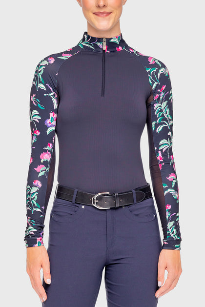 Front view of a female model wearing the Navy Garden Blooms Kastel Long Sleeve Raglan 1/4 Zip Sun Shirt on a plain background