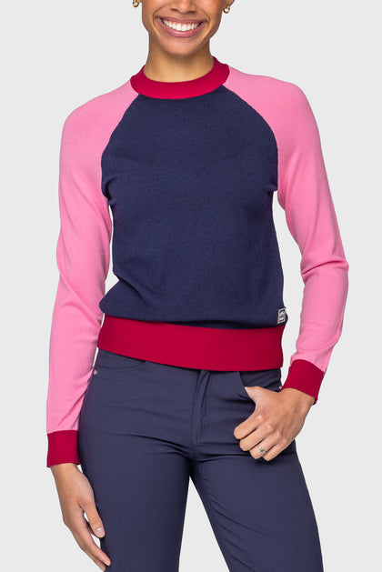 Front view of a model wearing the navy, hot pink, and wine Kastel Crewneck Sweater on a plain background