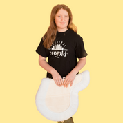 Front view of a young model holding the pony sized Ecogold Secure Hunter Pad on a yellow background