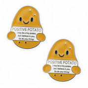 Front view of a pair of Positive Potato Dubois Cheval Number Pin Charm on a white background