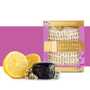 View of the Tea Tree and Lemon Myrtle whitening Hairy Pony Eco-Friendly Shampoo Bar with a lemon and white flowers on a purple and white color block background